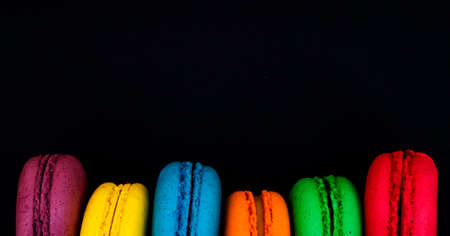 Sweet and colorful french macaroons or macaron on black background.の写真素材