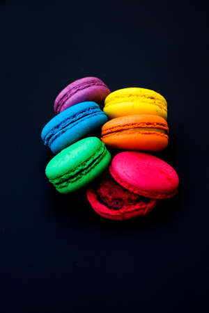 Sweet and colorful french macaroons or macaron on black background.の写真素材