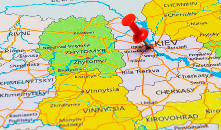 Map of Ukratne with a red push pin placed on the city of Kyiv. Selective focusの写真素材