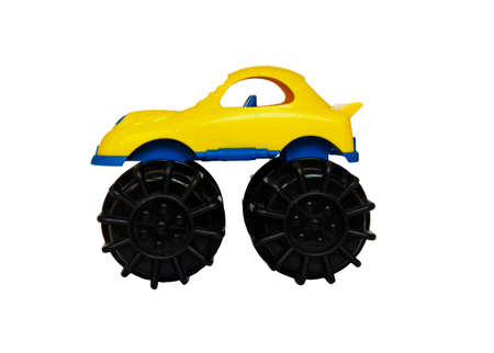 Childrens yellow plastic toy car on a white backgroundの写真素材