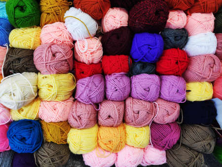 multicolored woolen threads in a ball for knitting close up, the concept of sewing, knitting and...