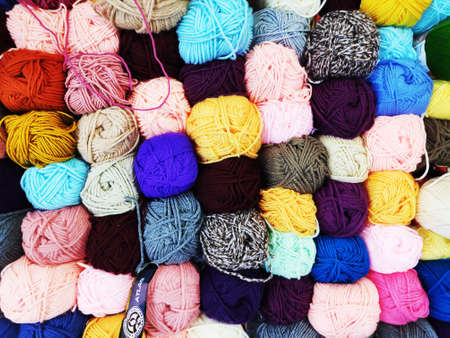 multicolored woolen threads in a ball for knitting close up, the concept of sewing, knitting and needleworkの写真素材