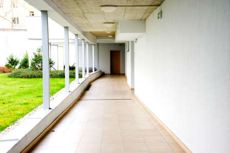 outdoor empty corridor with garden in the modern office building