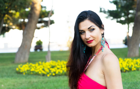 Beautiful brunette woman with blue eyes in the park,の写真素材