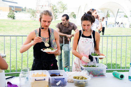 a guy and a girl show a master class on cooking vegetarian dishes.のeditorial素材