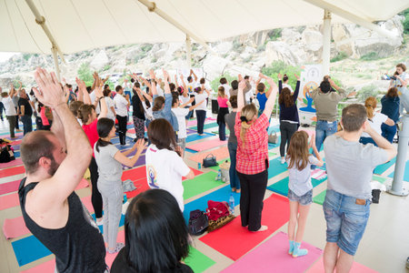 Baku, Azerbaijan-may 10, 2017: the mass of men, women and children meditate yoga in the open airのeditorial素材