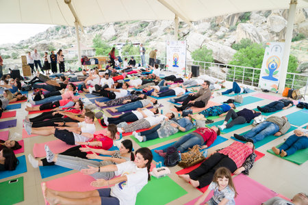 Baku, Azerbaijan-may 10, 2017: the mass of men, women and children meditate yoga in the open airのeditorial素材