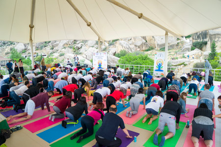 Baku, Azerbaijan-may 10, 2017: the mass of men, women and children meditate yoga in the open airのeditorial素材