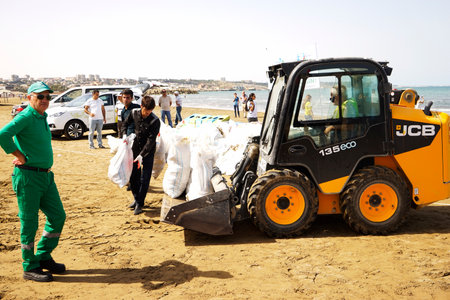 BAKU, AZERBAIJAN- JUNE 20, 2019 : young boys and girls, students clean up garbage on the seashore, on the beach. Environmental protection.のeditorial素材