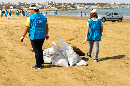 BAKU, AZERBAIJAN- JUNE 20, 2019 : young boys and girls, students clean up garbage on the seashore, on the beach. Environmental protectionのeditorial素材