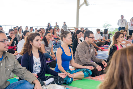 Baku, Azerbaijan-may 10, 2017: the mass of men, women and children meditate yogaのeditorial素材