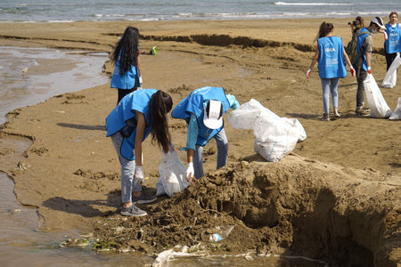BAKU, AZERBAIJAN- JUNE 20, 2019 : young boys and girls, students clean up garbage on the seashore, on the beach. Environmental protectionのeditorial素材