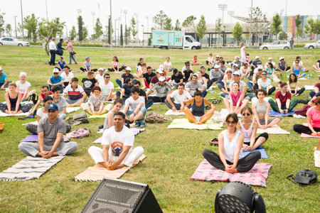 Baku, Azerbayjan, 23 july 2017: big group of adults attending a yoga class outside in park.のeditorial素材