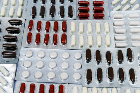 Abstract texture of blisters of multicolored round pills. Various diseases treatment concept. Medicines background, antibiotics sampleの写真素材