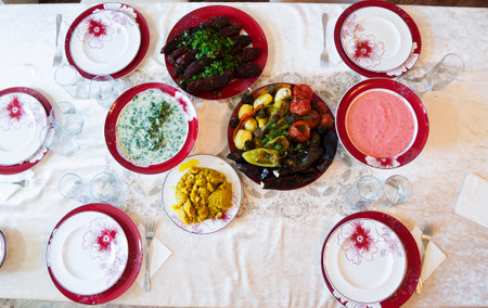 A variety of vegetarian dishes on the plates on the table.