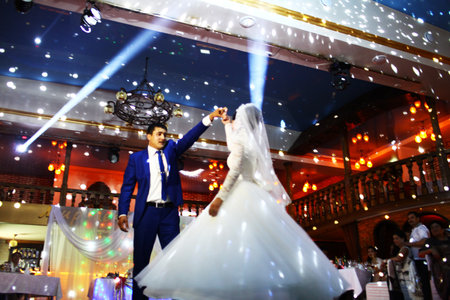 BAKU, AZERBAIJAN - JUNE 28, 2013: Happy bride and groom and their first dance, wedding in an elegant restaurant with wonderful lighting and atmosphere.のeditorial素材