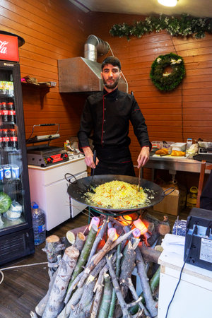 BAKU, AZERBAIJAN - DECEMBER 02, 2023 : Cook prepares pilaf, a dish of rice and meat on a campfire in the kitchen of the restaurant.のeditorial素材