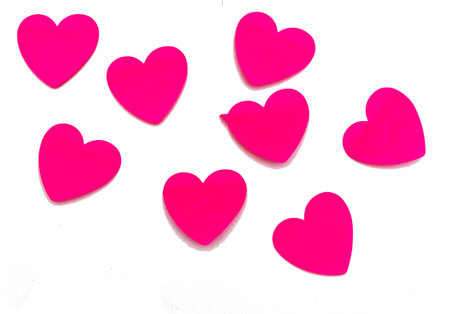 A set of stickers made of red and pink paper in the shape of hearts, layouts of empty label tags highlighted on a white backgroundの写真素材