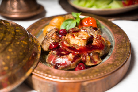 Roasted lamb shoulder with vegetables served on serving board .の写真素材