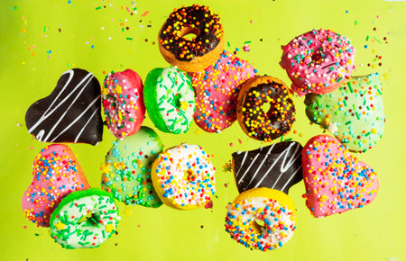 Multicolored donuts isolated on yellow background. Top viewの写真素材