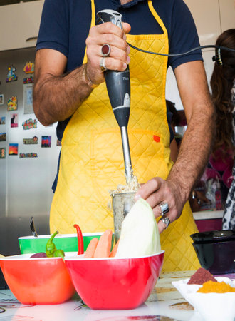 couple preparing food together in the kitchen of different vegetablesの写真素材
