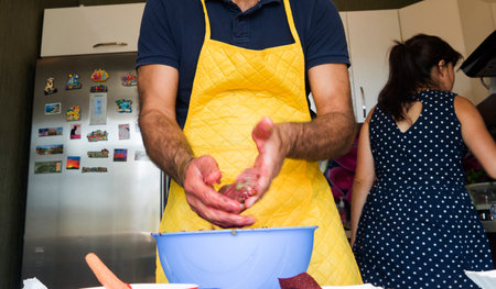 couple preparing food together in the kitchen of different vegetablesの写真素材