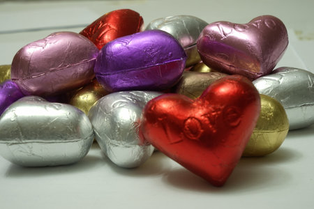 Multicolored heart shaped chocolates on a white background. close up. St. Valentine's Day Concept.の写真素材