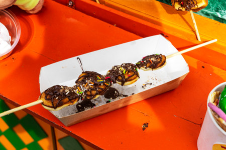 Waffles with chocolate, fruit and various fillings on a white plate.の写真素材