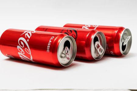 BAKU, AZERBAIJAN - January 01, 2013 : Red, tin three empty Coca-Cola cans on a white background.のeditorial素材