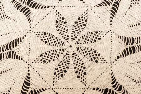 Vintage handmade white knitted napkin isolated on a black backgroundの写真素材