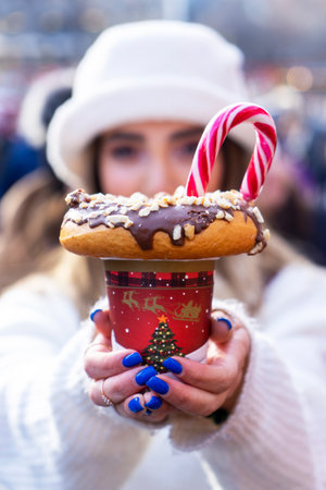 BAKU, AZERBAIJAN - JANUARY 01, 2013 : girl holding a milkshake with donuts and other sweets in a jarのeditorial素材