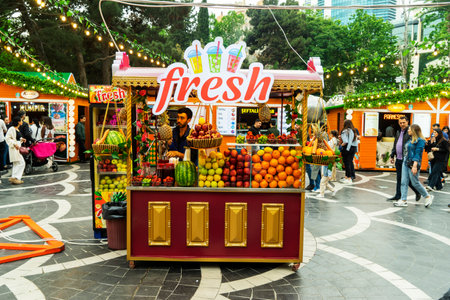 BAKU, AZERBAIJAN - MAY 20, 2020: Fruit and juices at the street farmers market. Fresh summer fruits for juice and smoothies. Summer, vitamins, healthy food concept.のeditorial素材