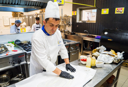 BAKU, AZERBAIJAN-24 MAY2019 : The chef also prepares lamb shank dishes. The process of cooking lamb shank male chef in a professional kitchen. Cooking meat in a Caucasian restaurantのeditorial素材
