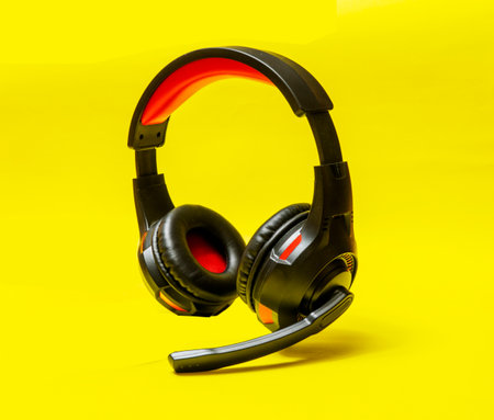 Wireless Over-Ear full size Headphones, Black leather isolated on yellow background with clipping pathの写真素材