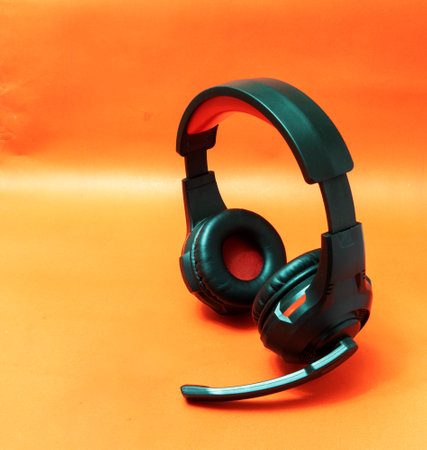 Wireless Over-Ear full size Headphones, Black leather isolated on red background with clipping pathの写真素材