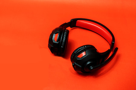 Wireless Over-Ear full size Headphones, Black leather isolated on red background with clipping pathの写真素材