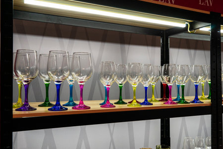 Elegant different wine and champagne glasses on a store shelf for sale. Shopping concept.