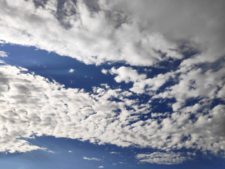 Blue sky background with cloudsの写真素材