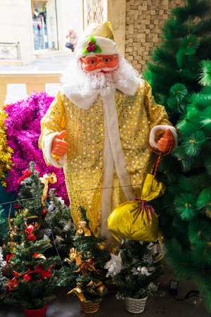 Santa Claus on a sled on wooden background with branches of Christmas treeの写真素材