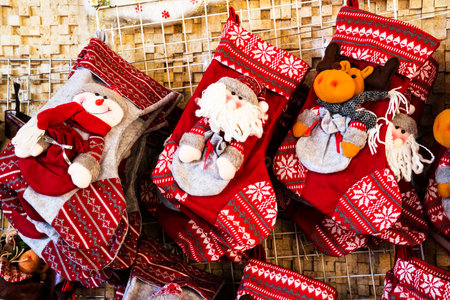 Christmas decoration stocking and toys hanging over rustic stone backgroundの写真素材