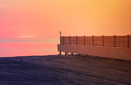 Pier in the sea mist at golden sunriseの写真素材