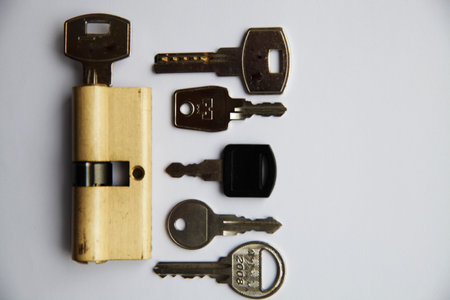 An interior door lock assembly and key on a white backgroundの写真素材