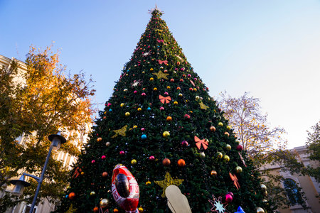 Beautiful Christmas toys on a Christmas tree with snow on city streetsの写真素材