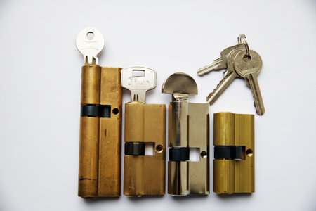 An interior door lock assembly and key on a white backgroundの写真素材