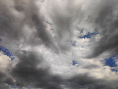 Dark, blue cloudy sky overlay. Dramatic sky and lightning. Bad weather with dark clouds.の写真素材