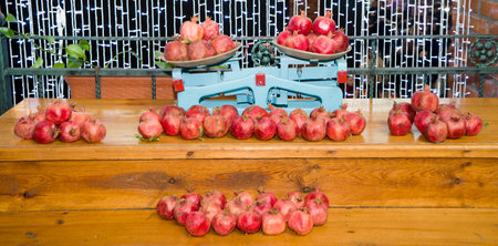 Red fruit pomegranates on the shelves, on the scales. fruit pomegranates, preparing for the holiday.の写真素材
