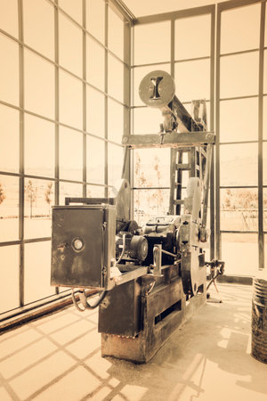 Old iron oil derrick pump.の写真素材