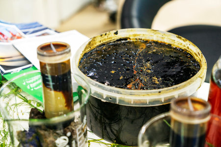 Various waste products, oil, fuel oil, gasoline in plastic and glass containers at the exhibitionの写真素材