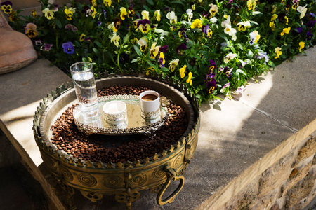 coffee in a white Cup, water, coffee beans on a tray is in the yardの写真素材