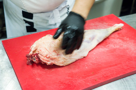 The chef also prepares lamb shank dishes. The process of cooking lamb shank male chef in a...